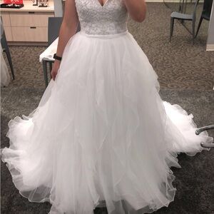 New with tags. Only worn to try on and has been in a garment bag since